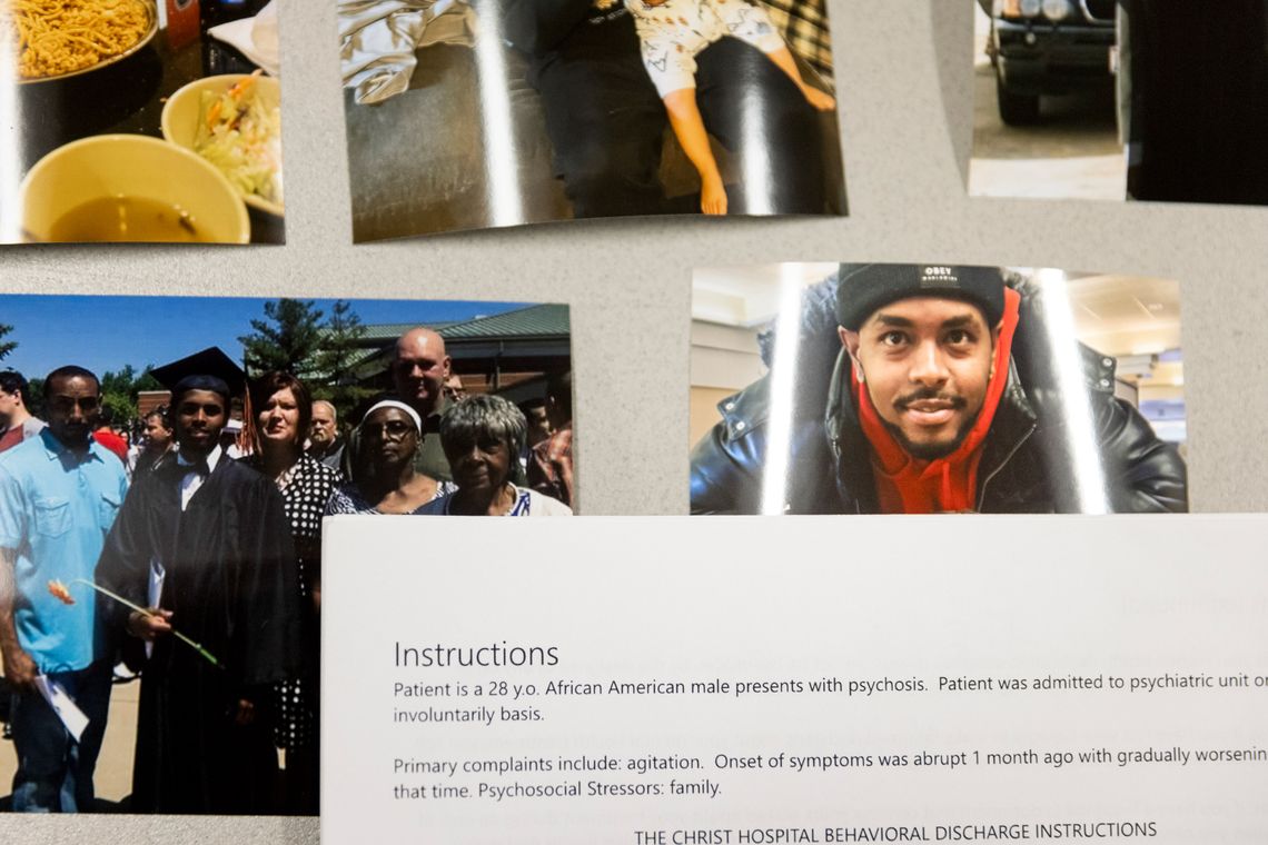 A photo of printed family photos and a hospital record on a table.
