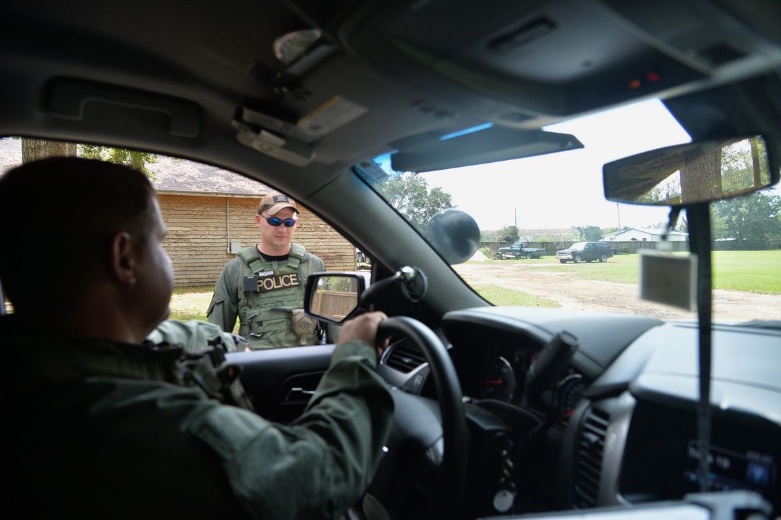 Sgt. Patrick McKean, left, of the police department in Mobile, Alabama, discusses his decision to call off a K-9 search for a suspect with Officer Justin Washam. McKean said patrol officers could arrest the person later, without dogs, once they got a warrant.