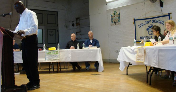 Ronald Leftwich arguing for the Norfolk Prison Debating Society during a debate with the Massachusetts Institute of Technology in 2017. Daniel Throop, center, looks on.