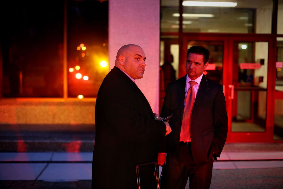 Patrick Megaro, left, Leon Brown's attorney, approved two $100,000 loans with an annual interest rate of 41.6 percent. Brown's legal guardian, Duane Gilliam, right, stands outside the federal courthouse in Raleigh, N.C., in 2017. 