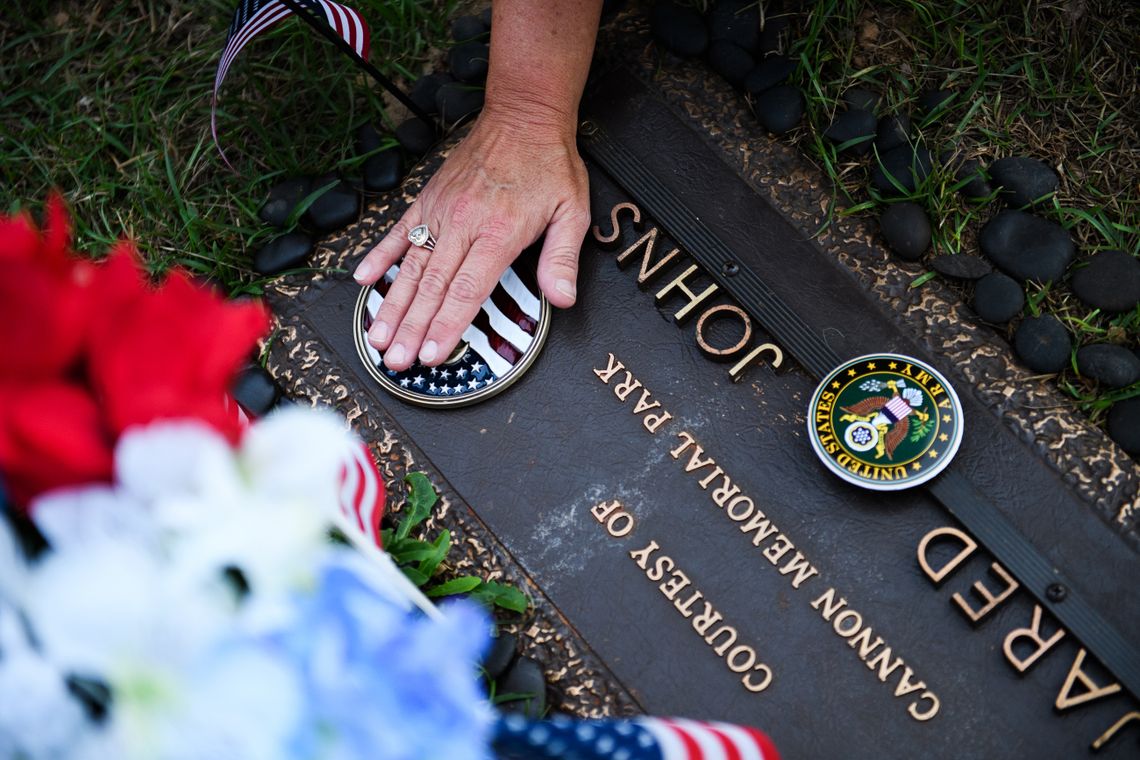 Kathy Bowling touches her son Jared’s grave. Jared committed suicide in 2018. 