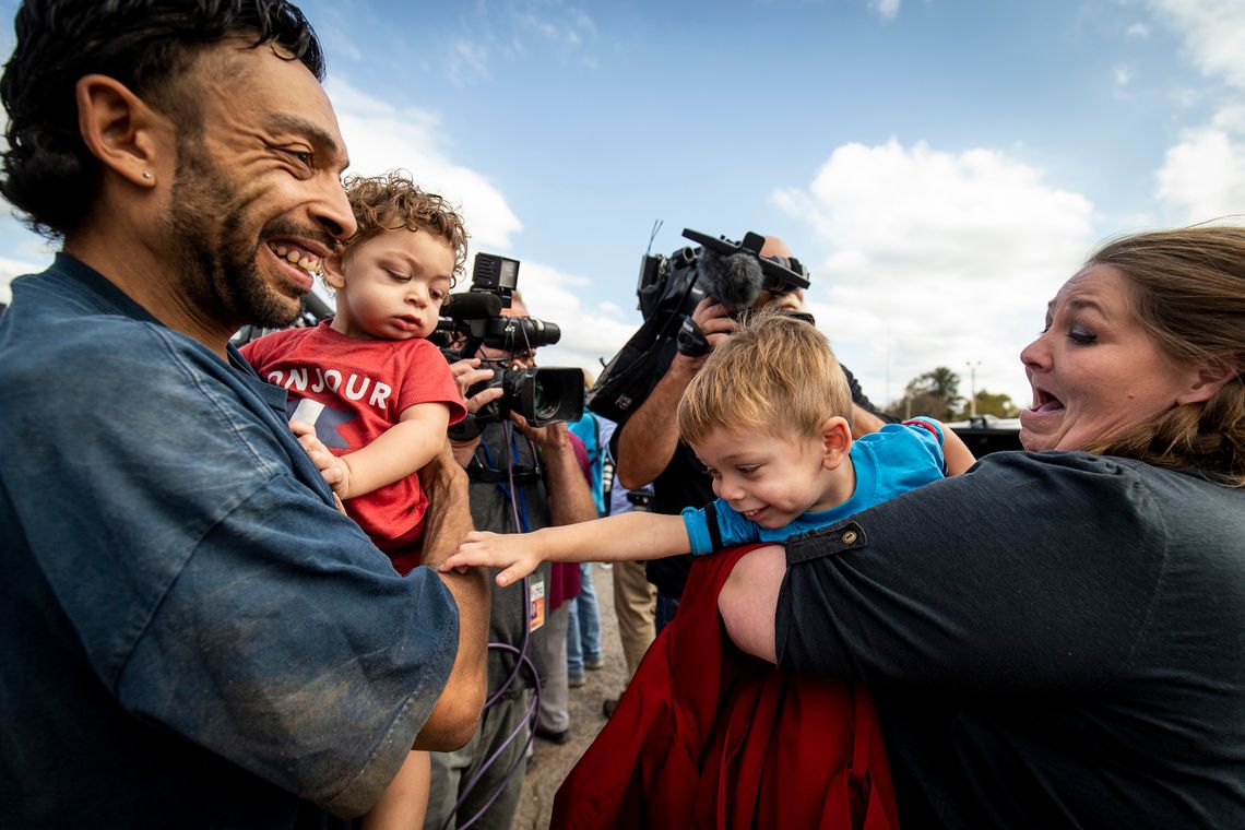 Donnie Sue Crow greets her boyfriend, Chris Davis, with their children, Faydon, left, and Chris, right. Crow was released from prison in Oklahoma along with hundreds of other people whose sentences were recently commuted.