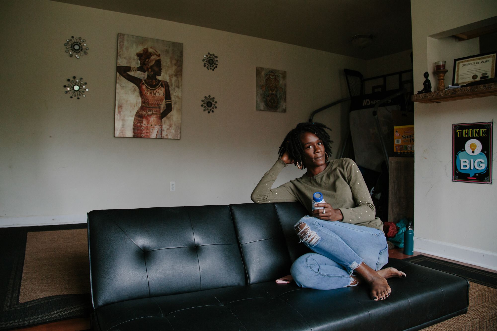 Chaney rests on a couch in her living room on Oct. 15, 2020. She lives in an apartment just four blocks from where her mother committed the double murders that locked her up.