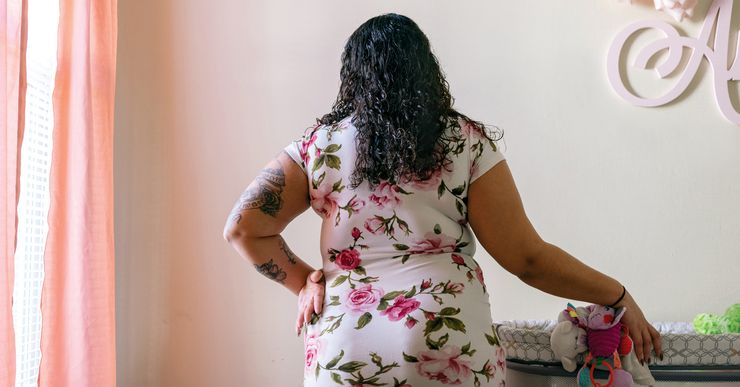 M., 23, stands in the room she has prepared for her daughter at her home in Massachusetts in March of 2021. Since her newborn daughter was placed in foster care, M. has been forced to bond with her primarily through Zoom.