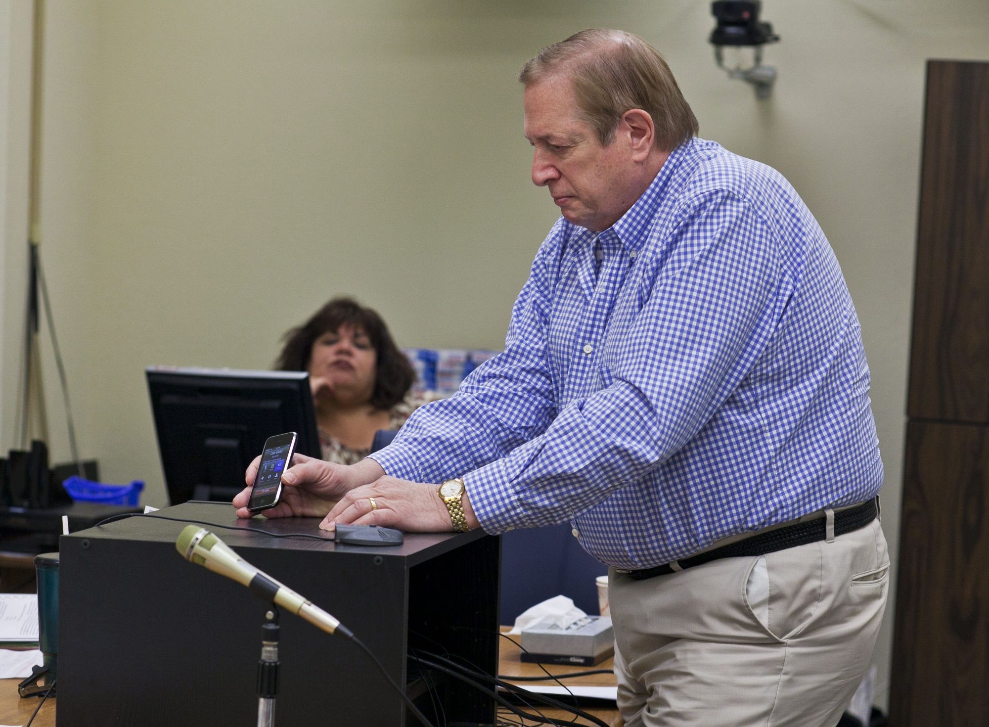 Sandy Kane, an older White man, speaks at a podium. 