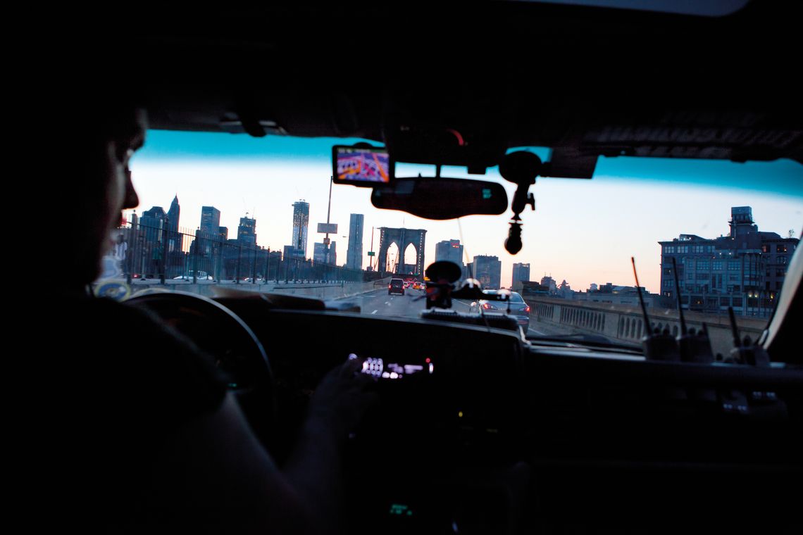 Bounty hunter Vinny Cornwell driving across the Brooklyn Bridge. 