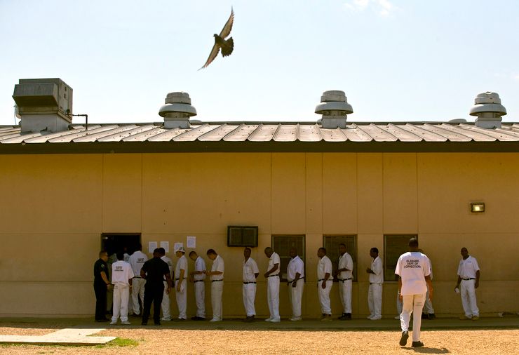 Prisoners stand in line at Elmore Correctional Facility in Elmore, Ala., in 2015. Thousands of Alabama prisoners began a work strike this week to protest poor prison conditions.