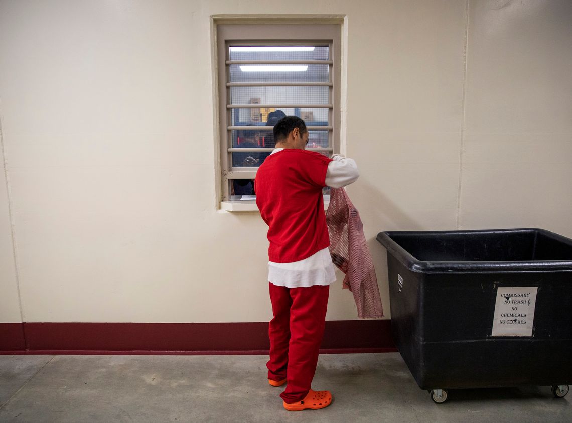 A detainee buys goods at the commissary at the Stewart Detention Center, which is run by CoreCivic, in Lumpkin, Ga., in 2019. 