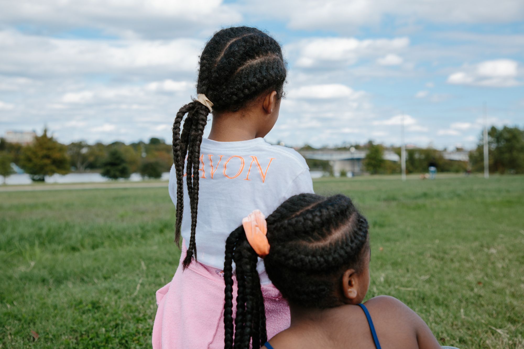 Chaney’s daughter, Aaliyah (left), and her friend people-watch in Anacostia Park after a yoga session on Oct. 18, 2020. After starting with her own children, Chaney began teaching yoga to women and children in the park, hoping to build wellness in her community.