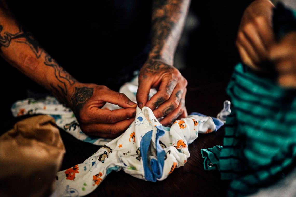 Josue Santiago folded his son Elihu’s onesie in Chicago, in July.