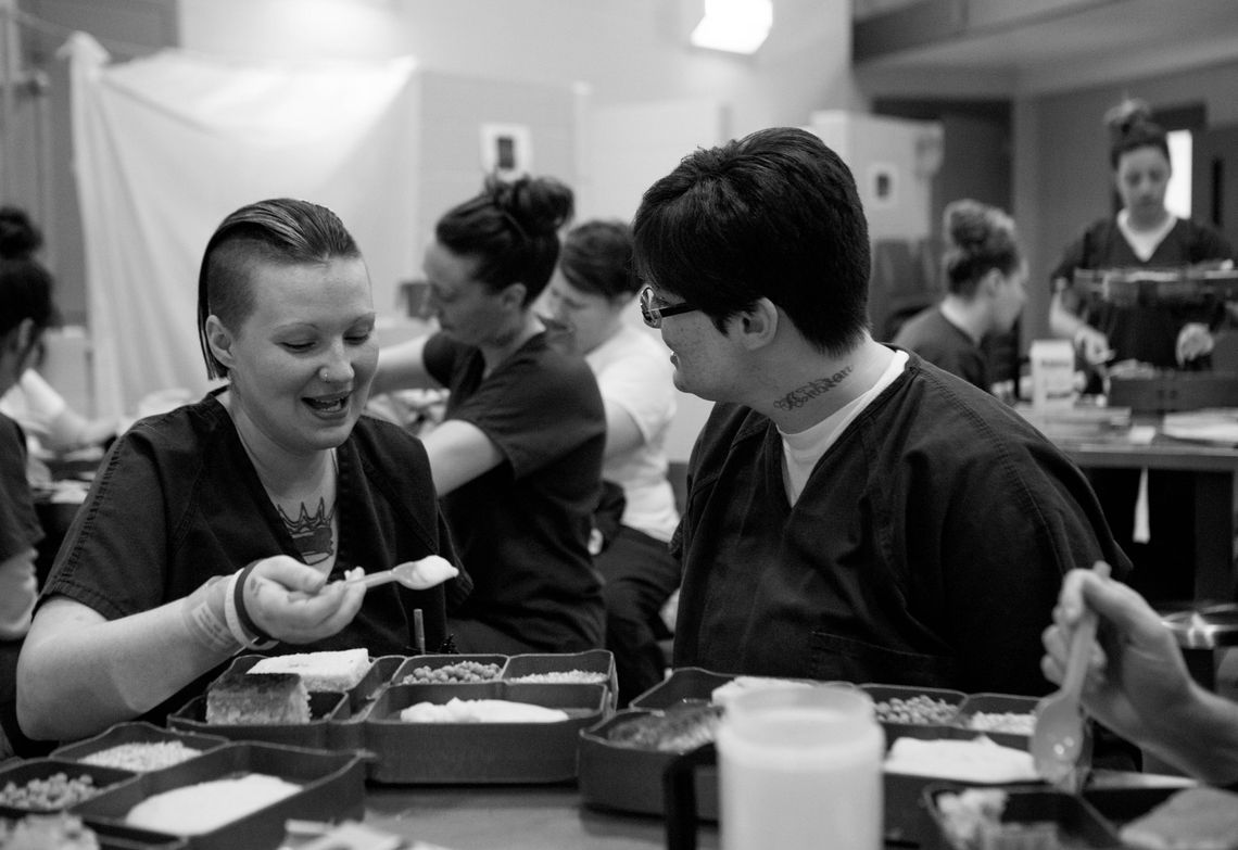 Tera, left, eats lunch with other HARP participants during a break between group sessions.