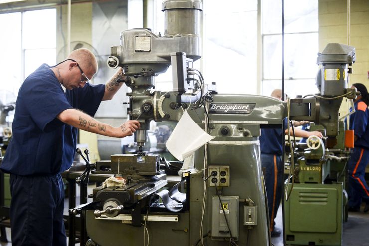 An inmate operates a machine in a tool shop as part of the Vocational Village program at the Richard A. Handlon Correctional Facility in Ionia, Mich.