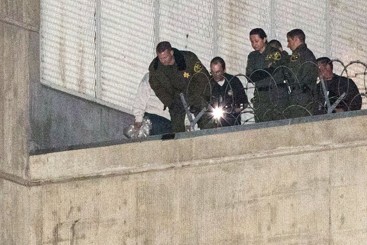 Orange County sheriff’s deputies investigate early Saturday morning, Jan. 23, 2016, after three jail inmates charged with violent crimes escaped from Central Men’s Jail in Santa Ana, Calif. The men include 20-year-old Jonathan Tieu, who is charged with murder; 37-year-old Hossein Nayeri, charged with kidnapping and torture; and 43-year-old Bac Duong, charged with attempted murder. Sheriff’s Lt. Jeff Hallock said Saturday that the inmates were last seen at 5 a.m. Friday morning and could have escaped anytime between then and late Friday night. (AP Photo/Kevin Warn)