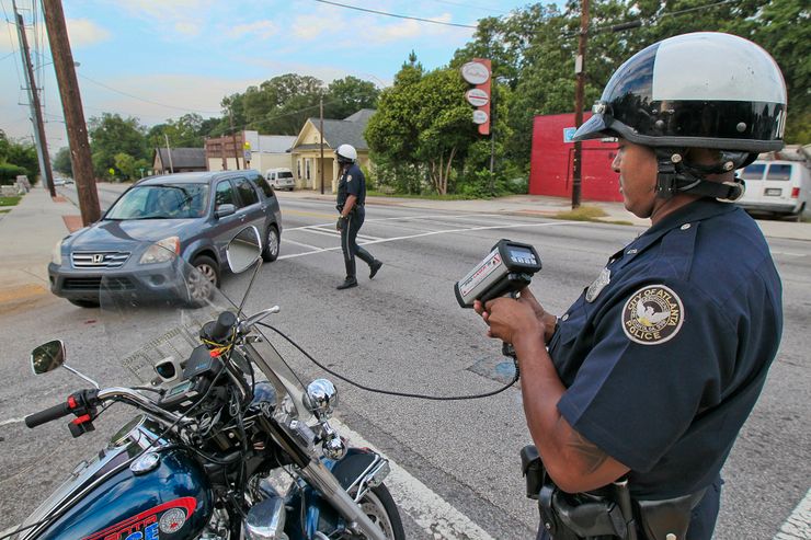 Police officers in Atlanta catch speeders with their laser guns.