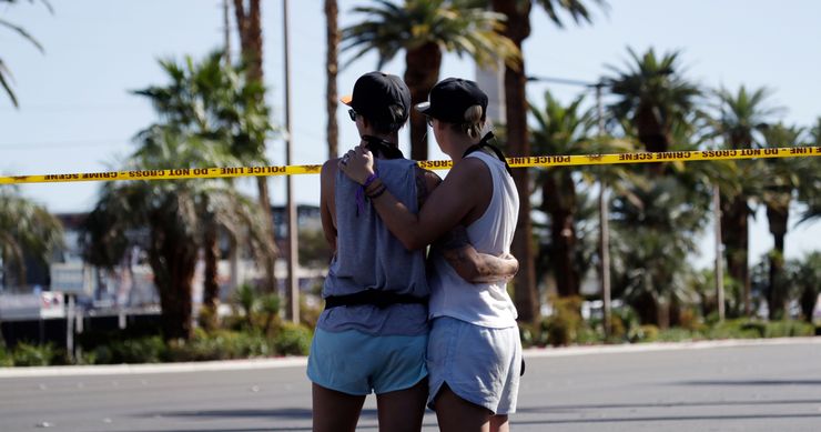 Two women embrace in front of the concert venue where a mass shooting took place on the Las Vegas Strip on Oct. 2.