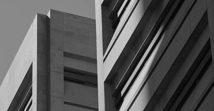 A black-and-white photo shows a concrete structure with narrow horizontal windows. 