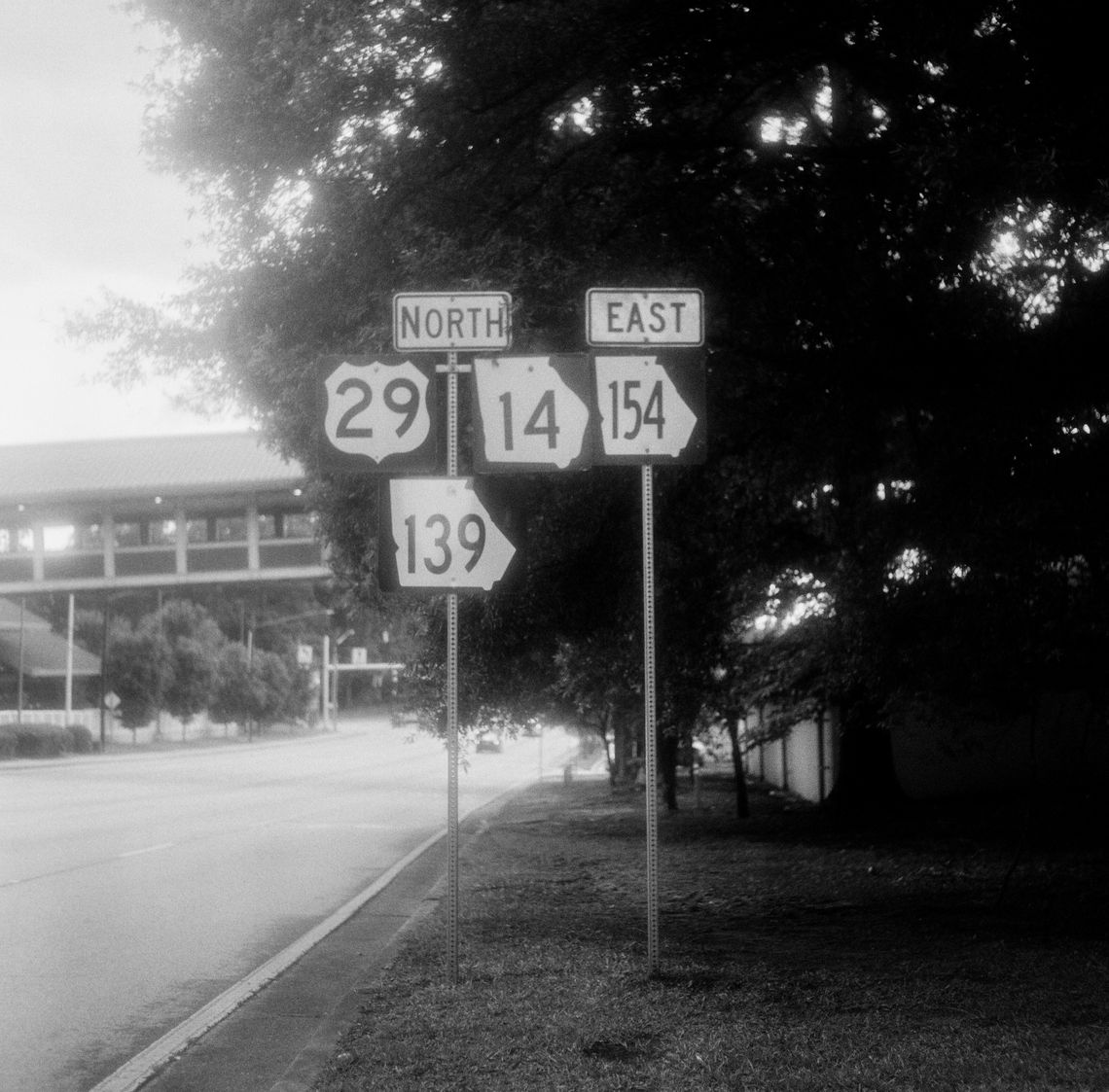 A black-and-white photo of state road signs in Atlanta. 