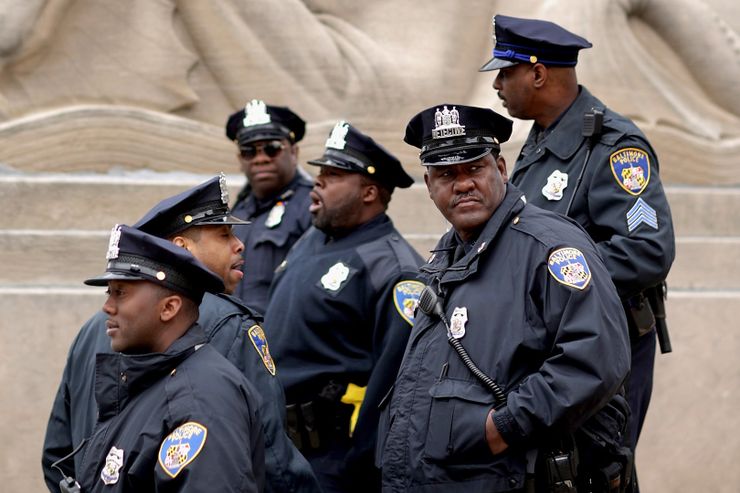 Baltimore Police officers monitor a protest against police brutality on April 23, three days after the death of Freddie Gray. 
