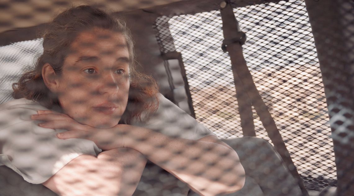 Misty Cook sits in the back of a prison van on her way to give birth. About 24 hours later, she was separated from her newborn son and returned to prison.