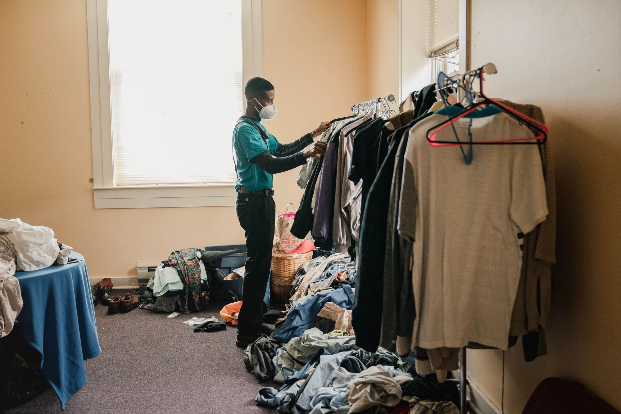 Jones picks out a coat at the Crisis Response Unit office to bring to a community member in need.
