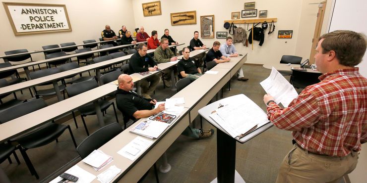 Anniston, Ala., police Sgt. William Parris speaks to first-shift officers during a roll call in 2015. 