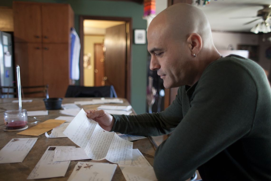 Chattler going through letters written to him from inmates.