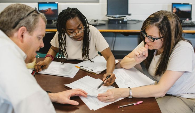 Michelle Jones, center, works on a housing policy proposal at Indiana Women’s Prison with Andrew Falk, left, a senior fellow at the Sagamore Institute, and Natalie Medley.