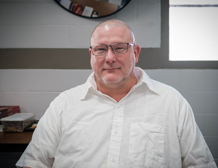 Brian Dorsey, a White man with glasses wearing a white shirt, at the Potosi Correctional Center. 