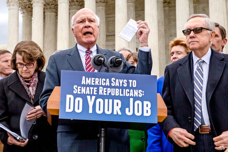 Sen. Patrick Leahy, D-Vt., the ranking member of the Senate Judiciary Committee, with Senate Minority Leader Harry Reid, D-Nev., right, and other Democrats, holds a copy of the Constitution as he urges Senate Republicans to relent on their decision to take no action on anyone President Barack Obama nominates to fill the Supreme Court vacancy created by the death of Justice Antonin Scalia, at the Supreme Court on Capitol Hill in Washington, Thursday, Feb. 25, 2016.  (AP Photo/J. Scott Applewhite)