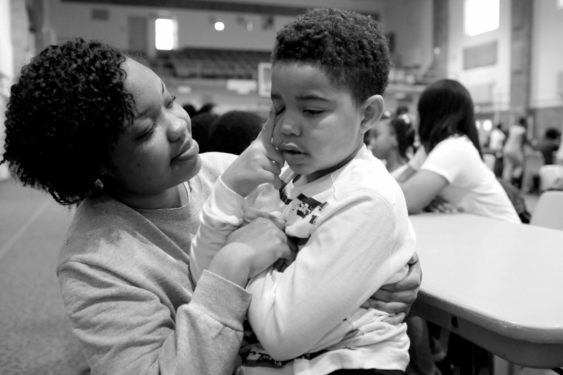 Lakeisha holds her son, Jayden, in the gymnasium at Logan Correctional Center.