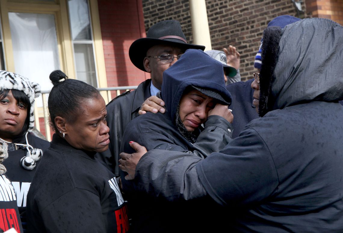 Janet Cooksey, center, the mother of Quintonio LeGrier, is comforted by family and friends during a press conference on the fatal shooting of her son by a Chicago police officer, in 2015.