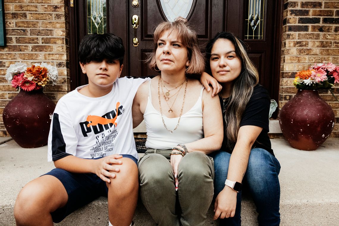 Maria Paz Perez and her children, Isabella and Xavier, outside their house. After her husband, Brigido Isidro Acosta, was deported in 2013, the family lost their home and had to move in with Maria's parents.