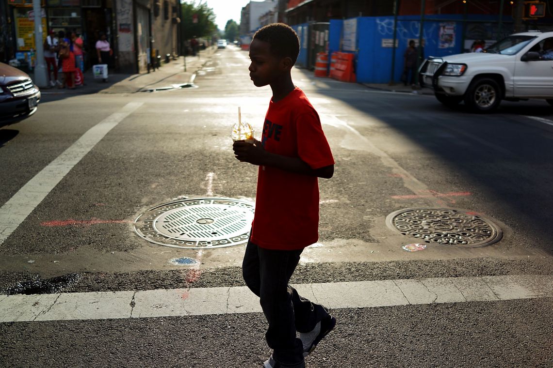 A boy walks down a Crown Heights, Brooklyn street in July 2013. 