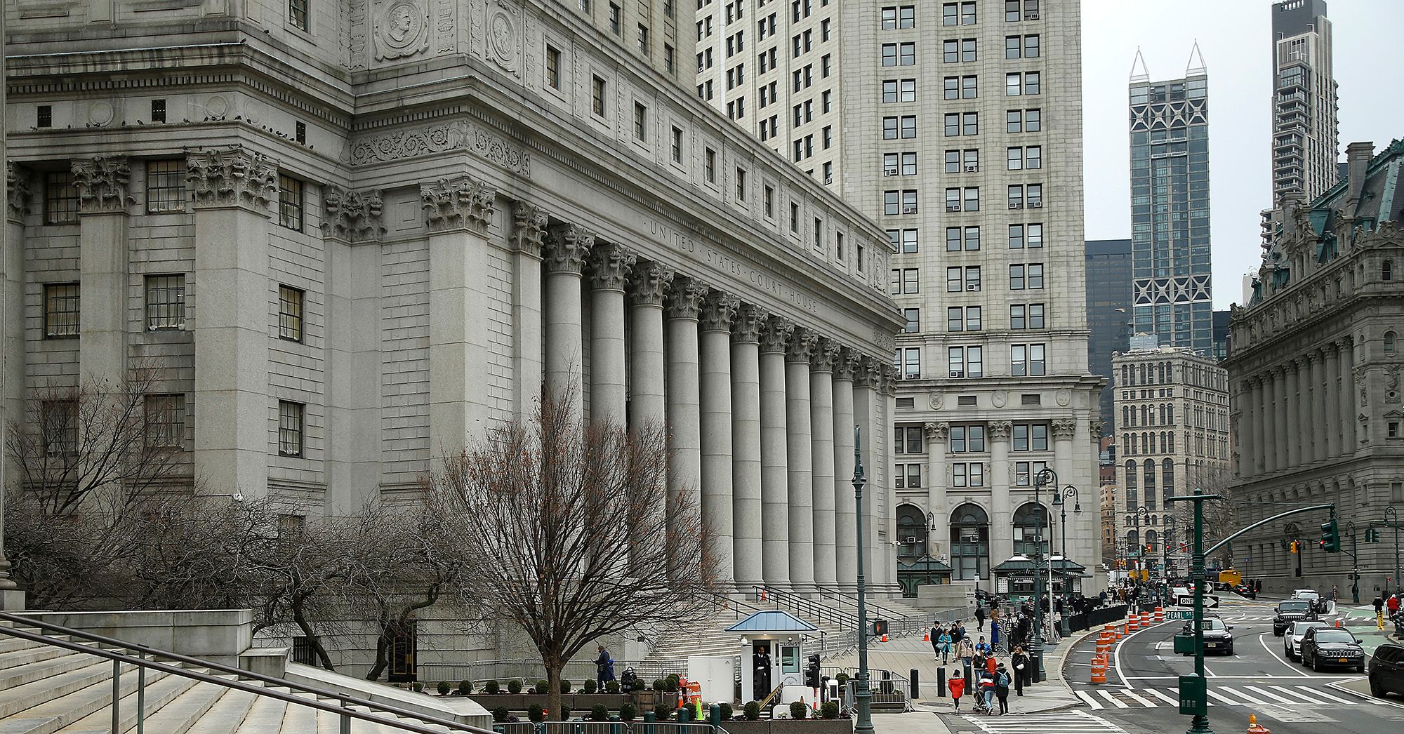 A gray building with a sign reads: "United States Courthouse."  