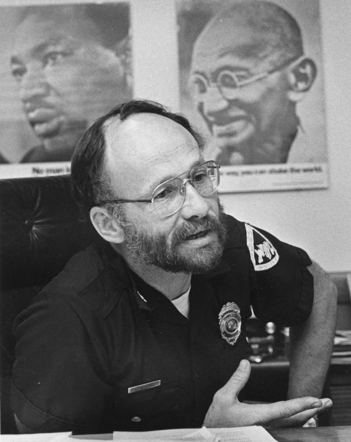 Former Madison Police Chief David Couper in his office with posters of Martin Luther King, Jr. and Mahatma Gandhi, in Wisconsin.