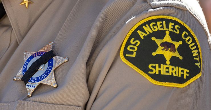 Los Angeles County Sheriff Robert Luna wears a black mourning band over his badge during a press conference at the Palmdale Sheriff’s Station on Sept. 18, 2023. 