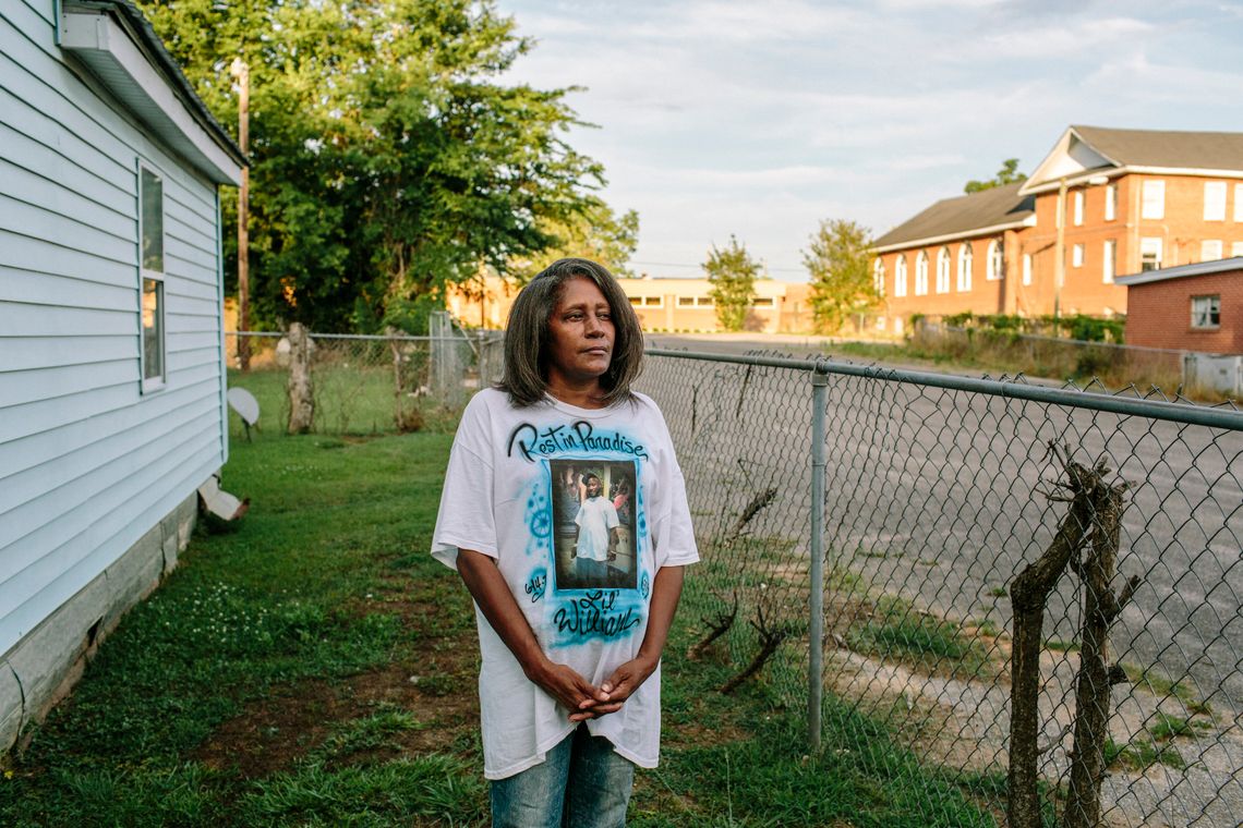 Connie Ewing stands in her yard wearing a memorial T-shirt dedicated to her son, William Culpepper Jr., in Meridian, Miss.