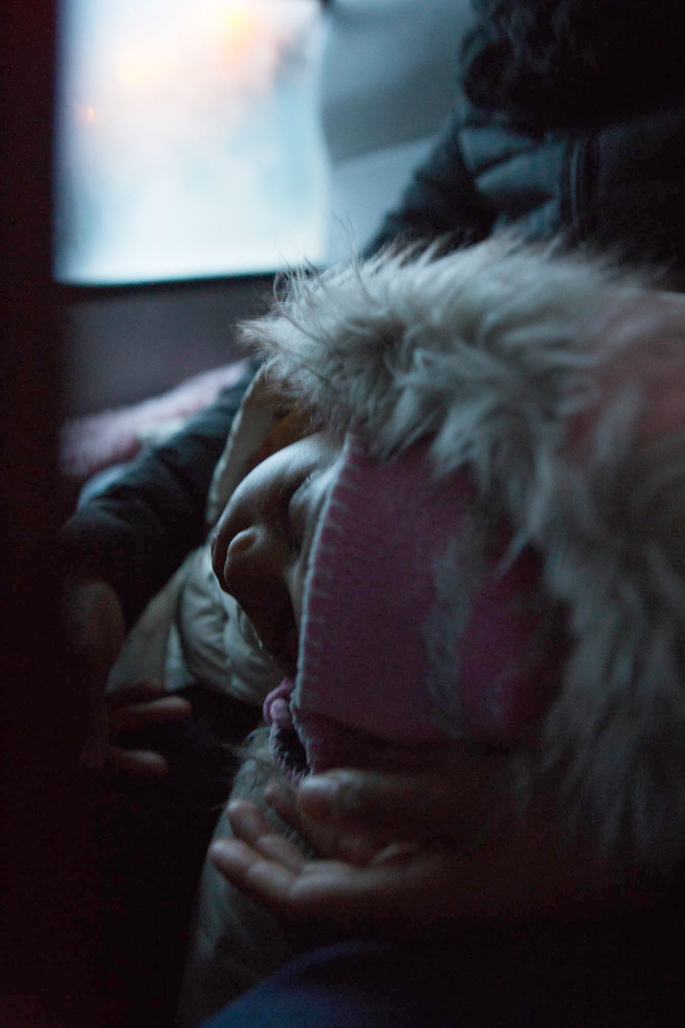 NEW YORK - Dec. 14, 2019: Truly Escobar, 4, sleeps in her mother Tayla's lap on the early morning bus ride to Bedford Hills Correctional Facility on Saturday. CREDIT: Cassandra Giraldo for The Marshall Project