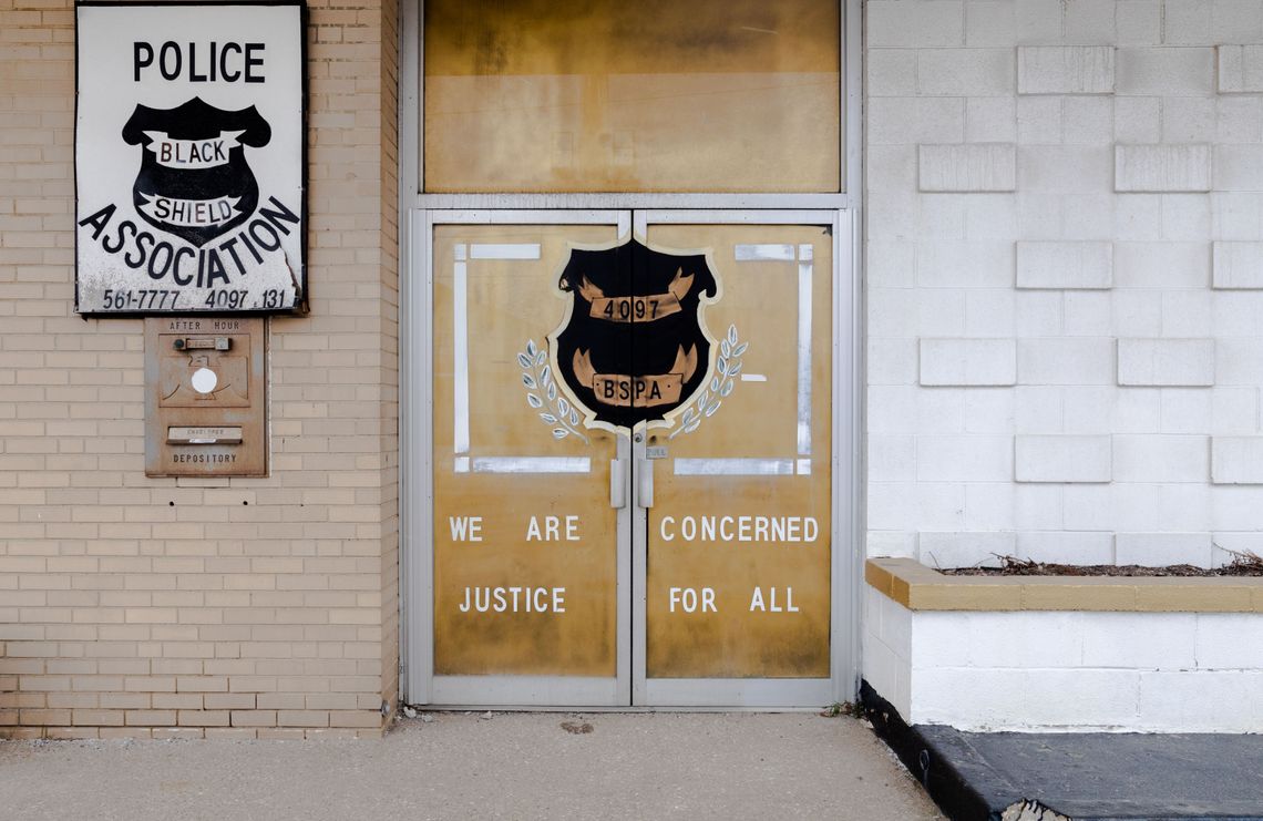 The Black Shield headquarters, with the shield logo and the words “We are concerned” and “Justice for all” on the doors. 