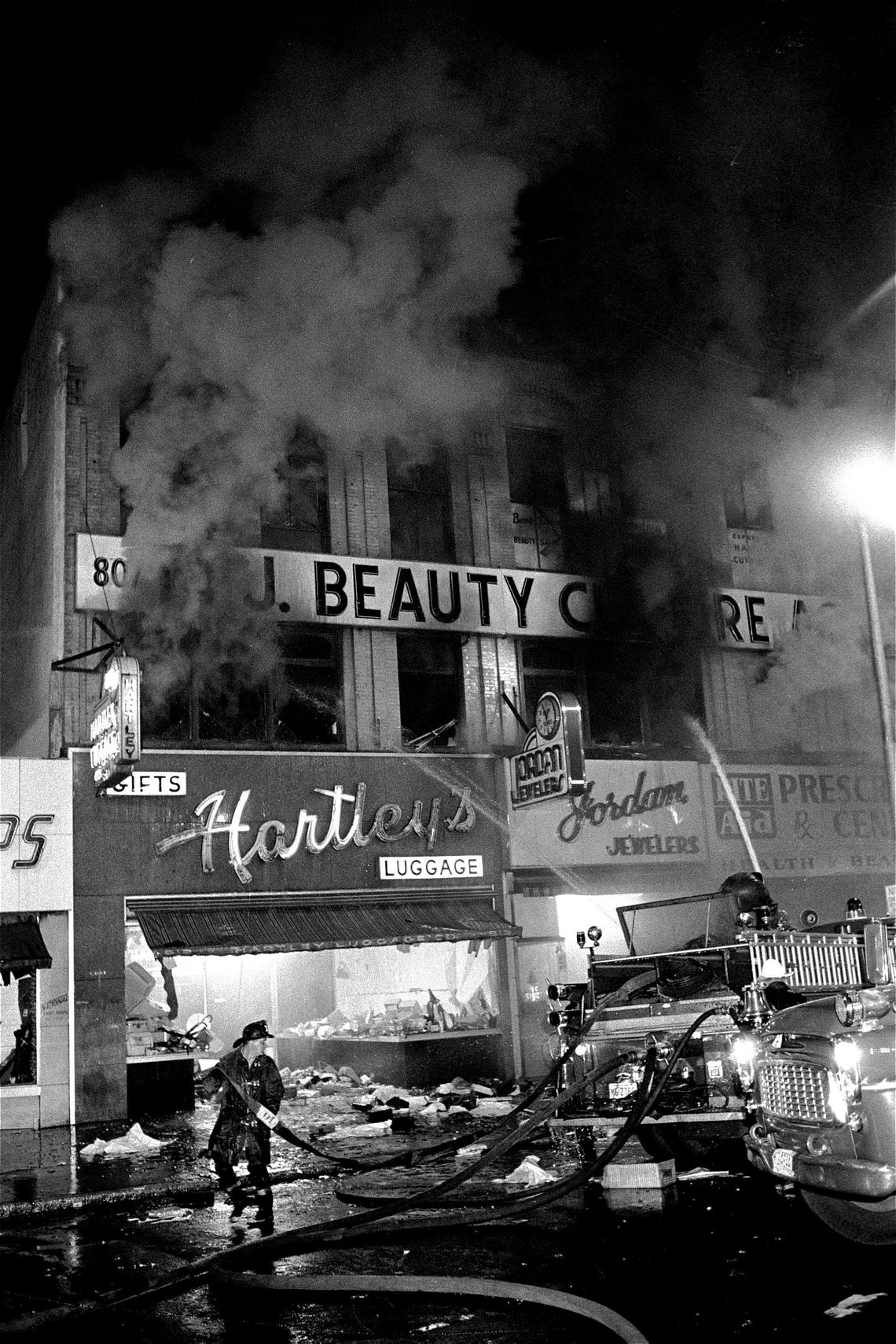 Firemen work at burning buildings on Broad Street in Newark, N.J., in 1967.