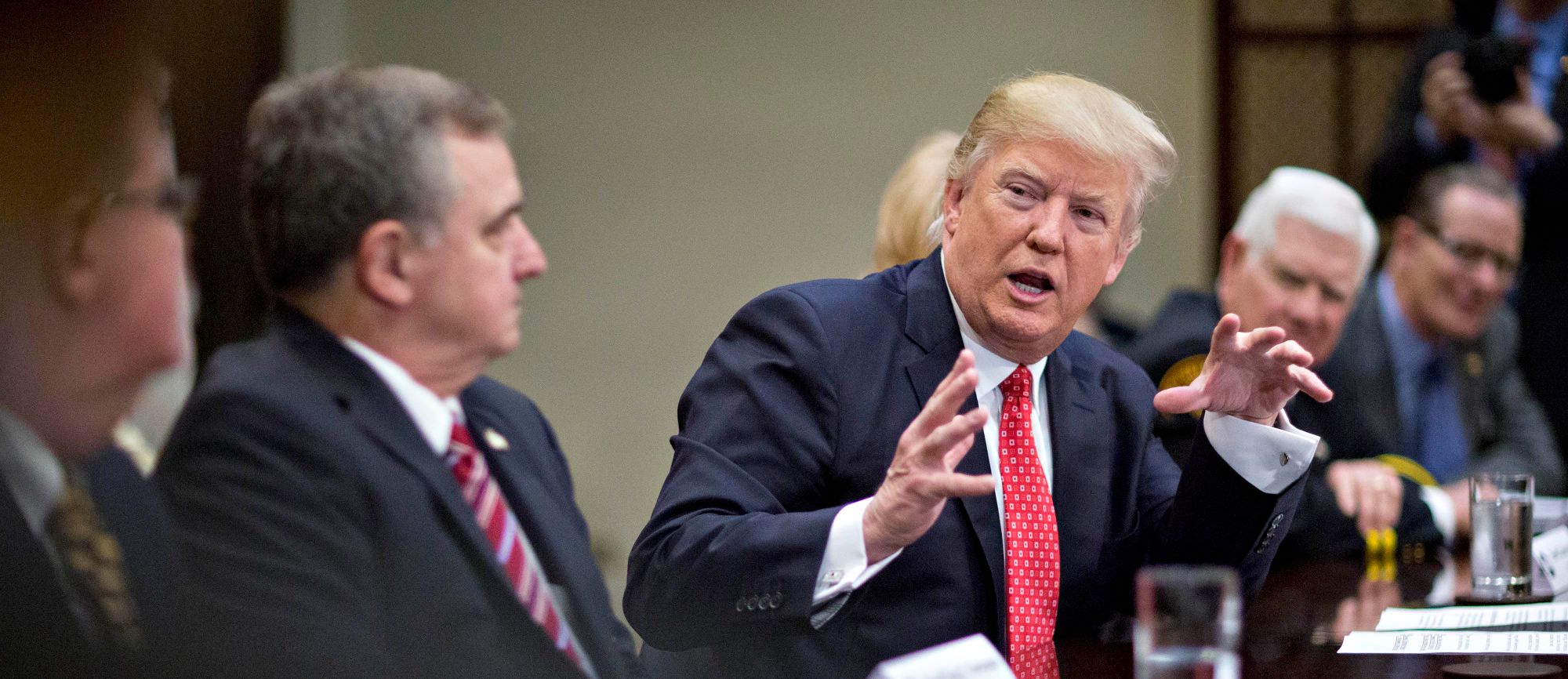 President Donald Trump meets with county sheriffs during a listening session in the White House.