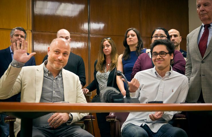 Adam Sirios, left, raises his hand to confirm he was the lone holdout juror, after a mistrial was declared in the murder case against Pedro Hernandez at the Supreme Court in Manhattan on May 8. 