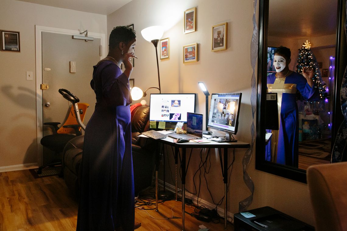 G. King mimes in front of computer monitors in her home on Dec. 17, 2020 for an event with women who are returning from prison. After turning to miming as a tool to express herself and heal in prison, King now uses miming as a form of ministry and connectivity at events and in her church in Washington, D.C.