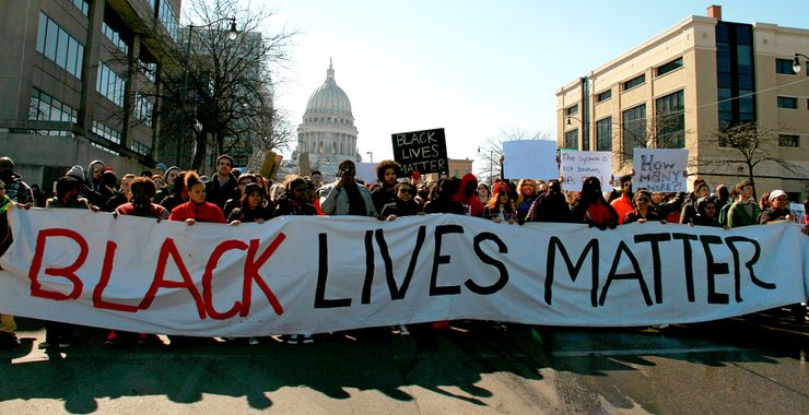 Protesters march through the streets of Madison, Wis., one day after the shooting death of Tony Robinson. 