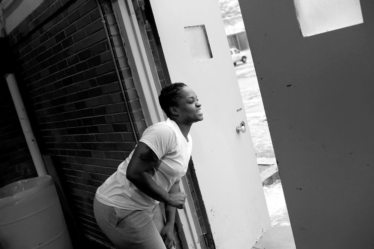 Dyanna braves the cold to catch a peek of her sons walking toward the gym at Illinois’ Logan Correctional Center.