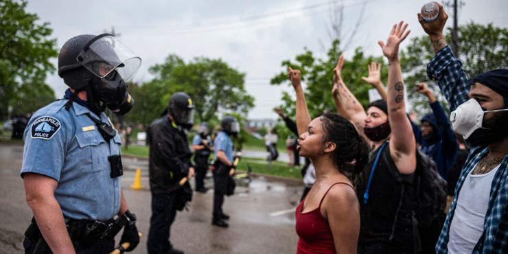 Protesters and police officers faced each other during a rally against the death of George Floyd in Minneapolis in May. 