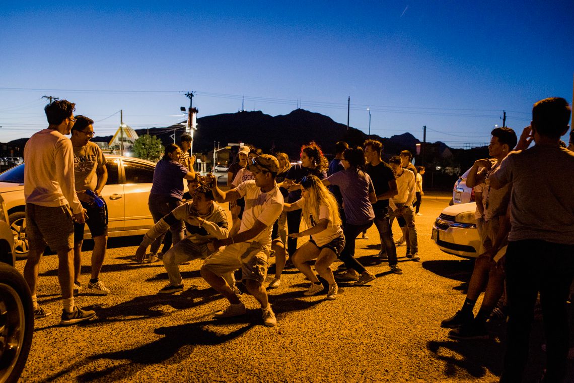 Students dance in the parking lot of Bowie during "Senior Sunset," an annual event where the graduating class watches their last sunset as seniors together.