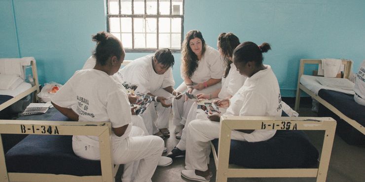 Pregnant and post-partum mothers from the film ‘Tutwiler’ share photos of their children with each other at the Julia Tutwiler Prison for Women in Wetumpka, Alabama.