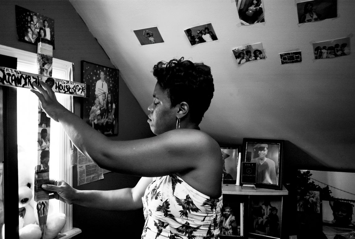 Montika Lowe displays a memorial cross in her daughter’s room on June 27, 2013. The daughter, Qua’Nyrah Houston, 15, and her boyfriend were killed in 2012 in a fire, which was later ruled by police to be arson. No one has been charged in the killing.