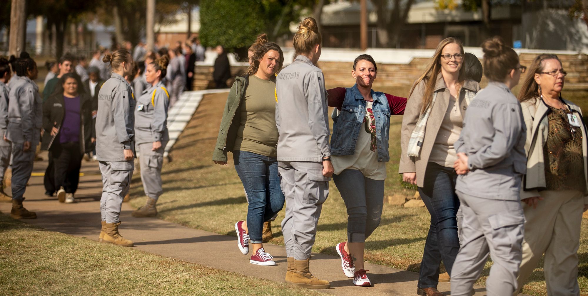 Tana Hackley pats a friend on the shoulder as she leaves prison as a result of Oklahoma’s mass commutation of hundreds of people’s sentences for low-level drug and theft cases.